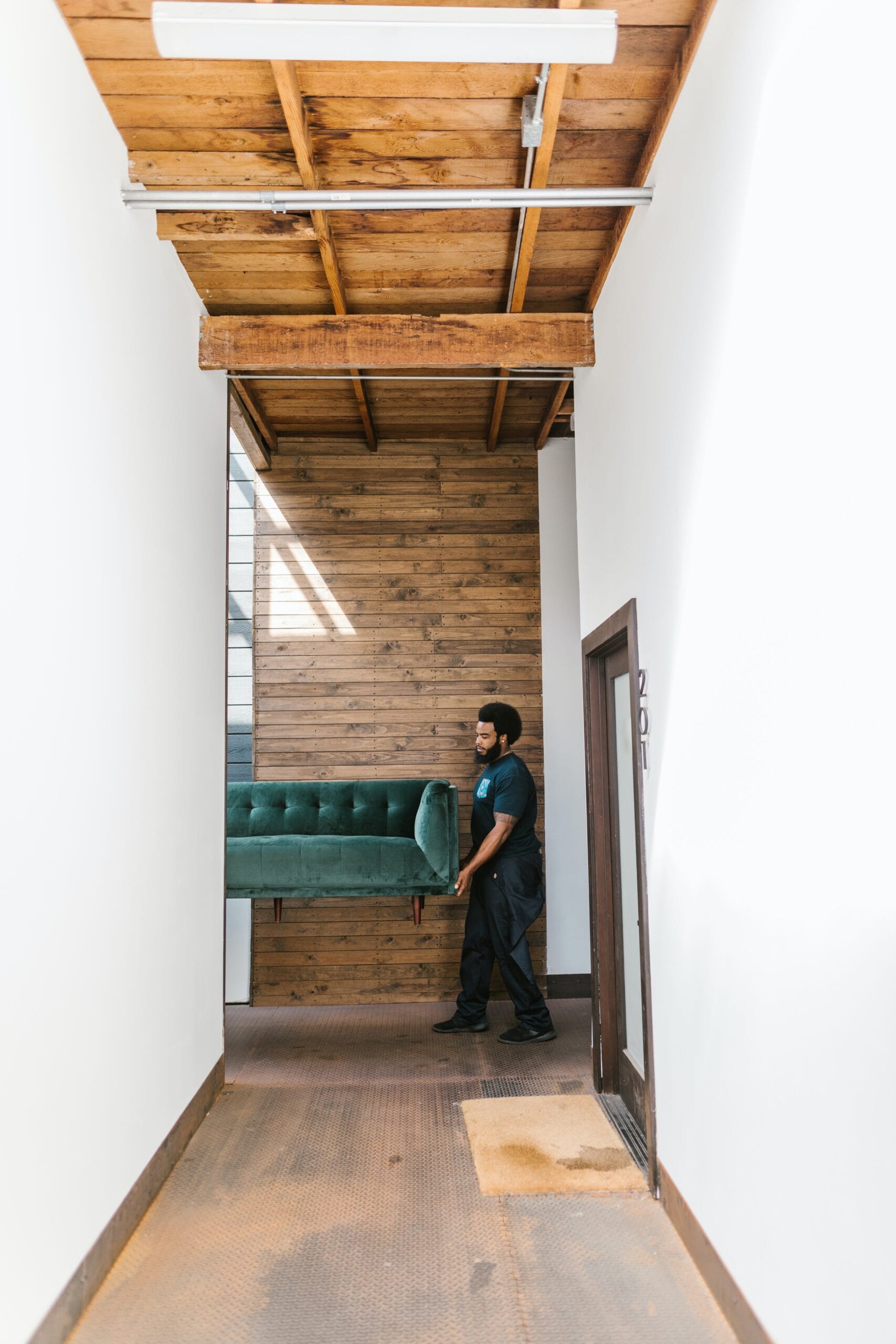 Toronto movers moving a green sofa