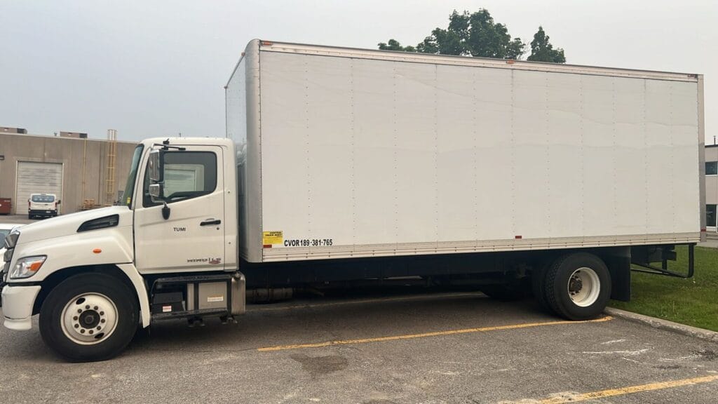 Side view of a 24ft white moving truck parked in Toronto, used for large home moves