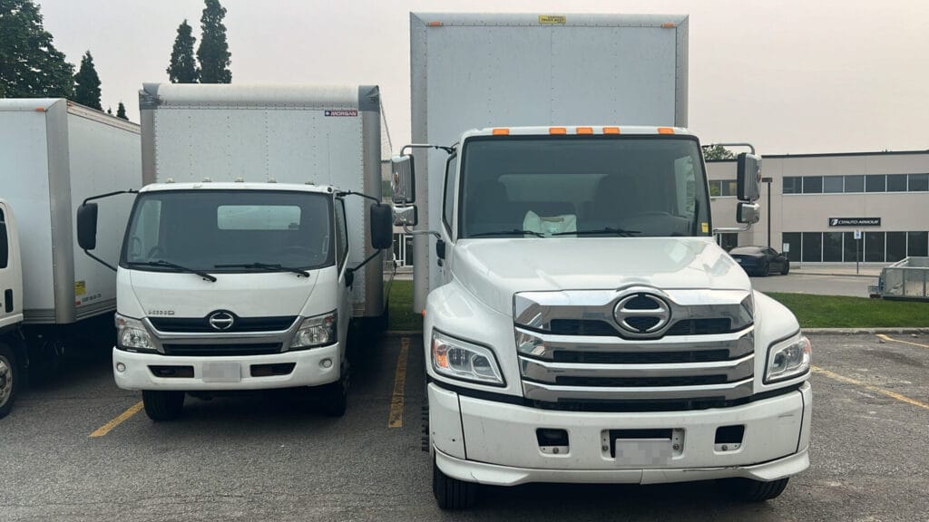 Front view of a 20ft and 24ft moving truck parked side by side in Toronto