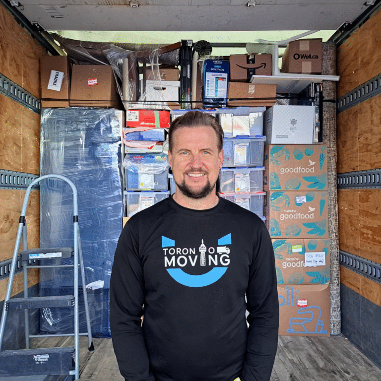 Toronto mover standing in a fully packed moving truck ready for an end-of-lease move