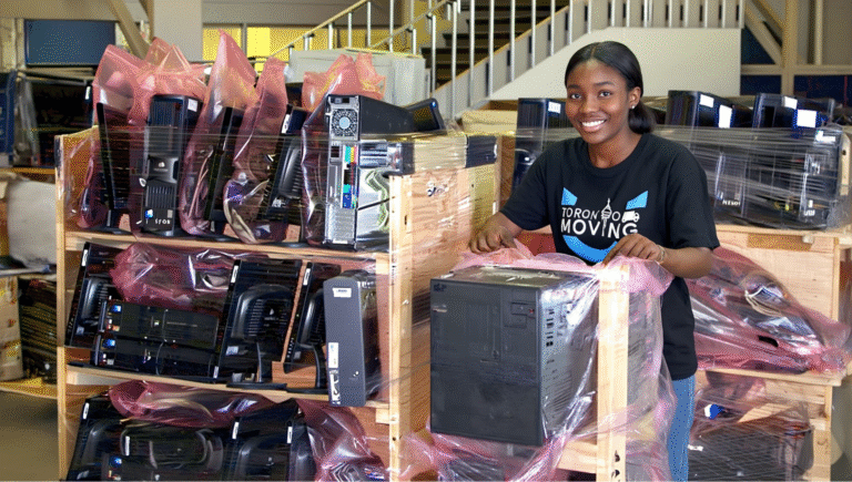 Mover applying anti-static wrap to a computer during IT equipment relocation in Toronto