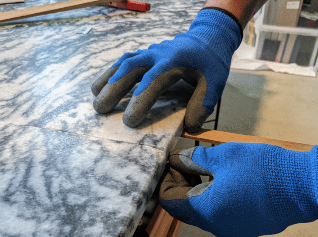 Cracked marble tabletop showing damage from improper storage or temperature change during moving